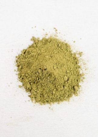 A small pile of matcha powder on a white background.